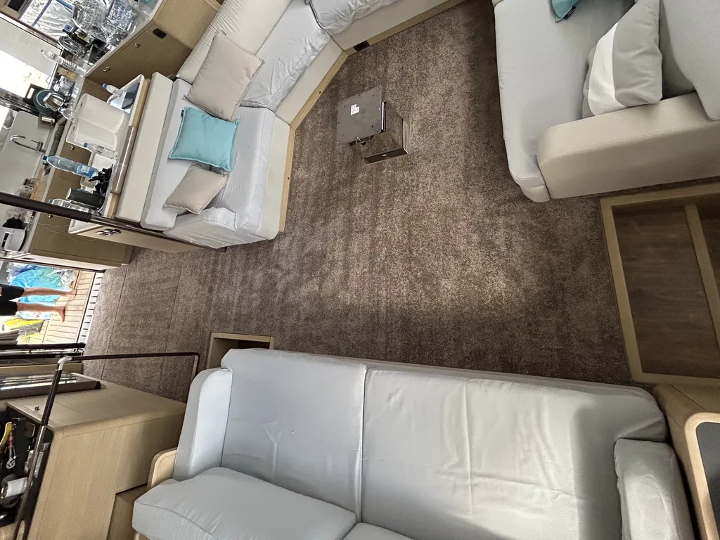 Fitted carpet running through a yacht's saloon between two seating areas