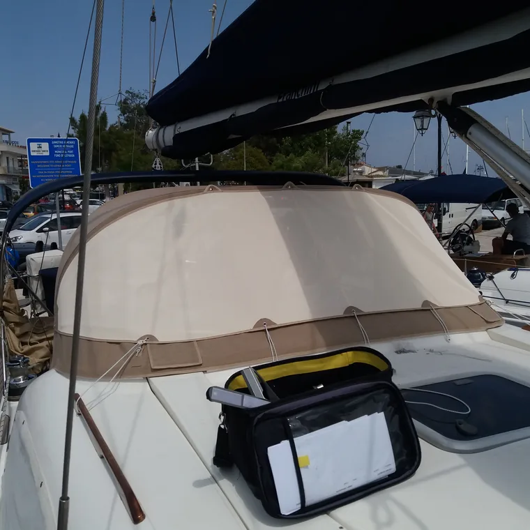 Tan sprayhood over the companionway, seen down a teak side deck