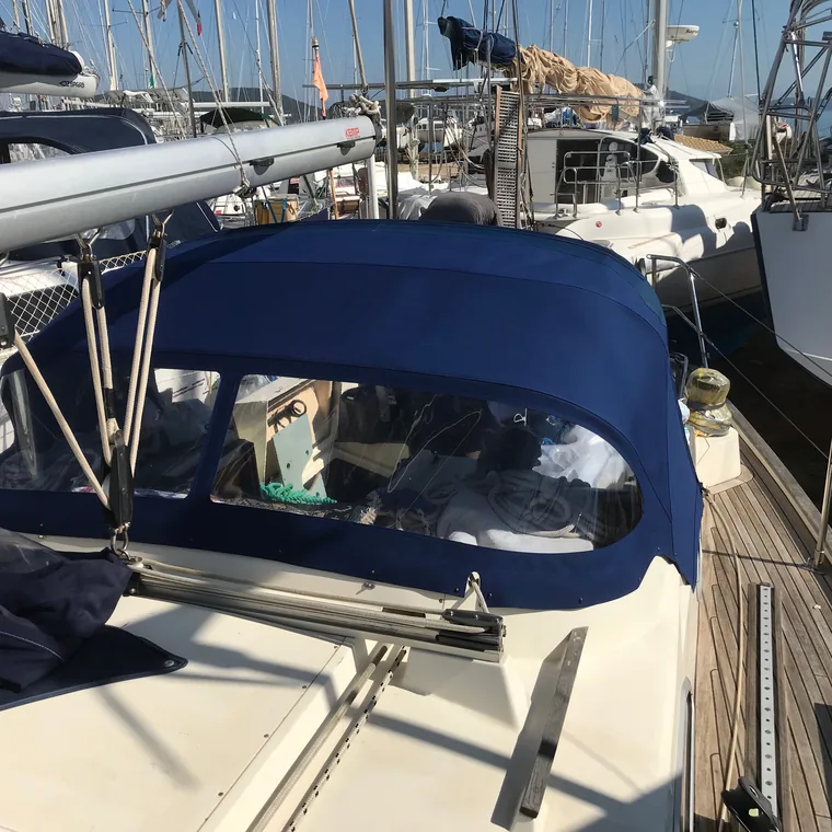 Navy sprayhood folded and covered on the coachroof