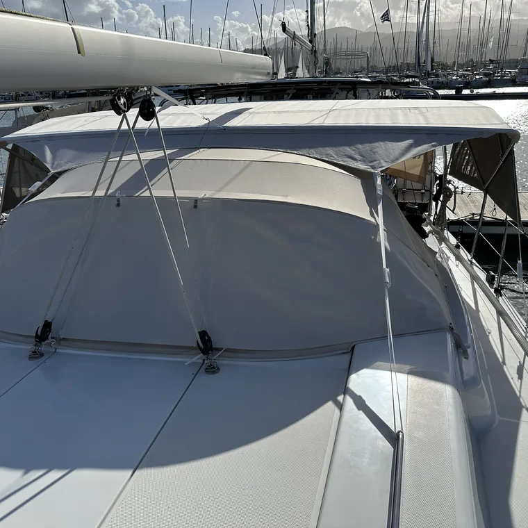 Cream sprayhood and boom seen along the deck of a yacht