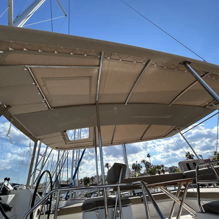 Underside of a cream bimini against a clear sky