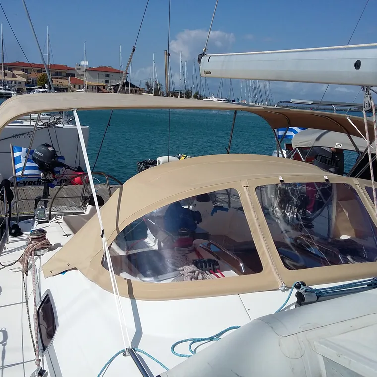 Cream sprayhood with clear windows on a yacht berthed stern-to