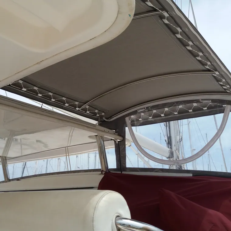 Cream bimini seen from below, stretched over the boom
