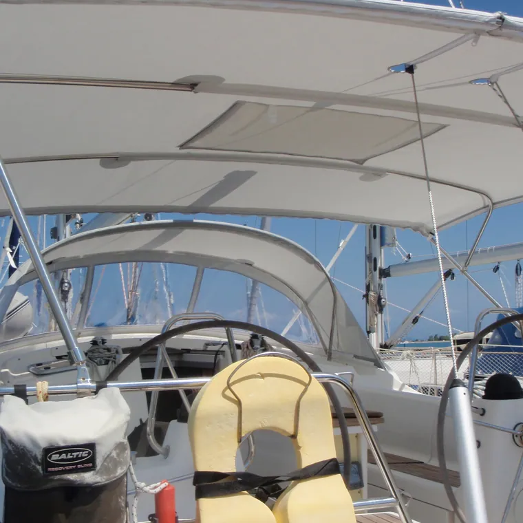 Bimini seen from below over the wheel, blue sky through the frame