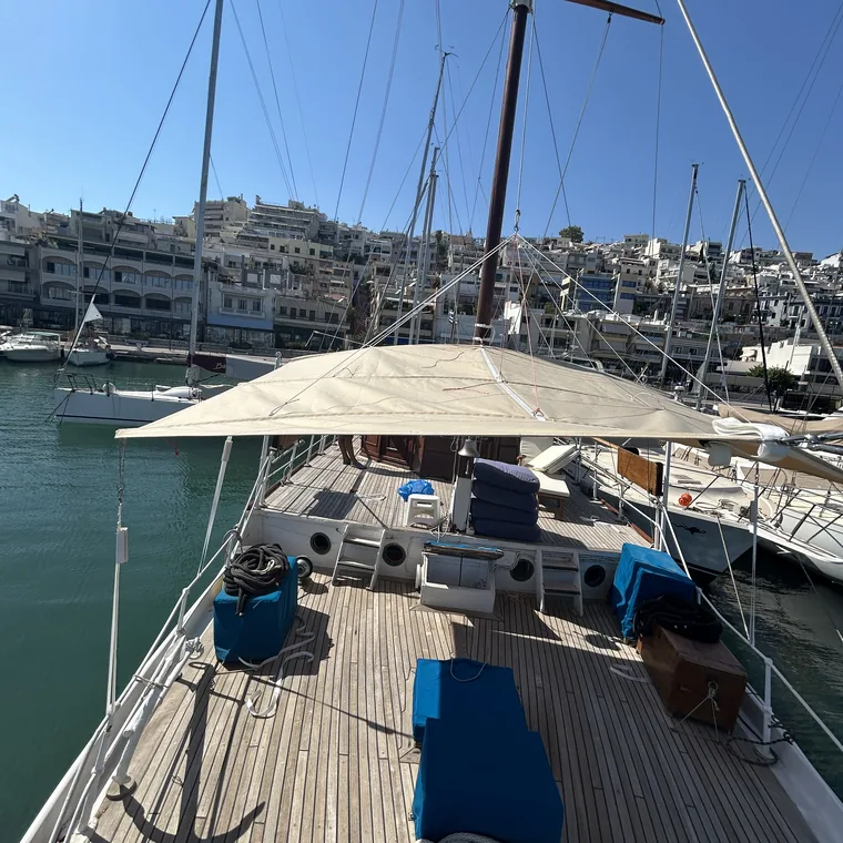 Tan awning over the cockpit, the marina beyond