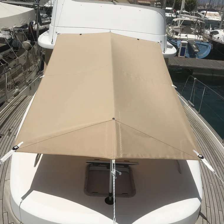 Cream awning shading the foredeck at anchor