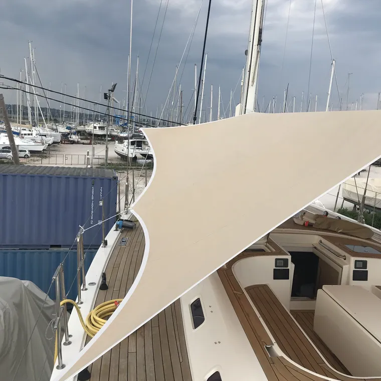 Cream shade sail tensioned above the side deck