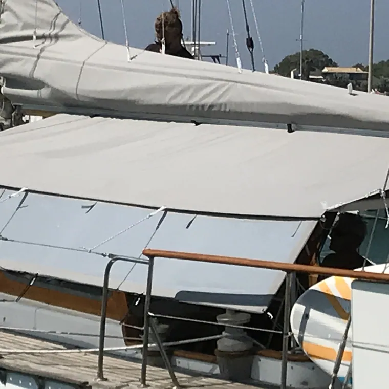 Long white awning running down the side deck of a classic yacht