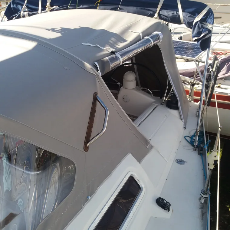 Grey cockpit enclosure zipped shut on a motor yacht