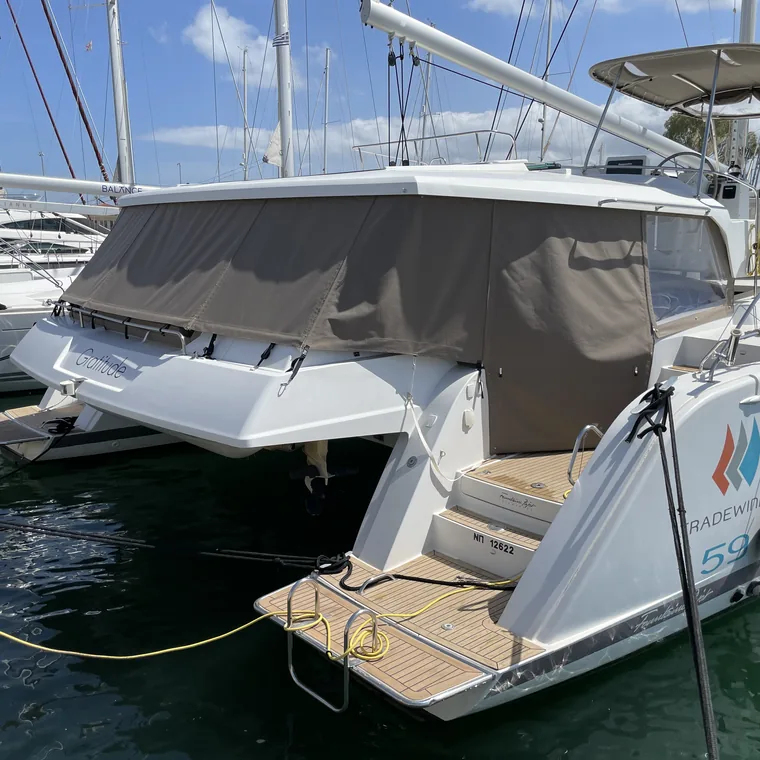 Grey enclosure across the cockpit of a catamaran