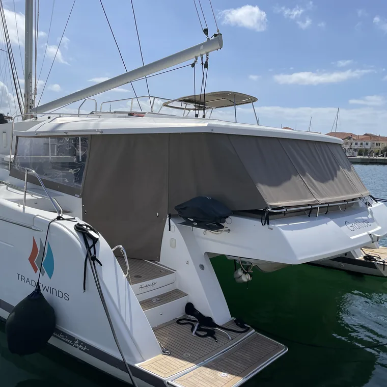 Cockpit enclosure on a catamaran over clear water