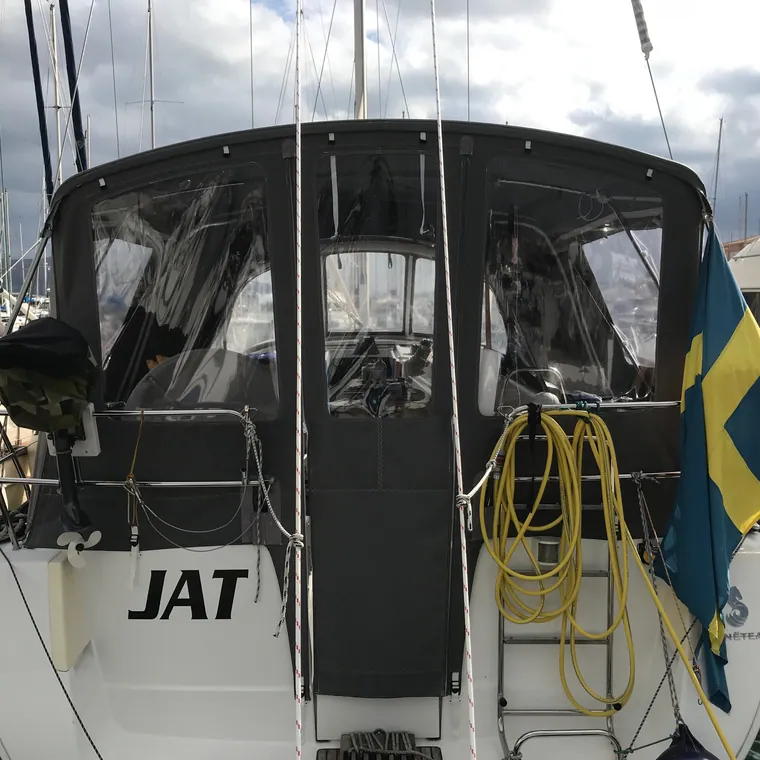 Cockpit enclosure seen from astern, zipped shut over the wheel