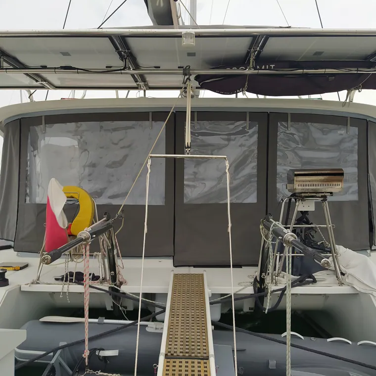 Clear panels of a cockpit enclosure over the teak deck of a large sailing yacht