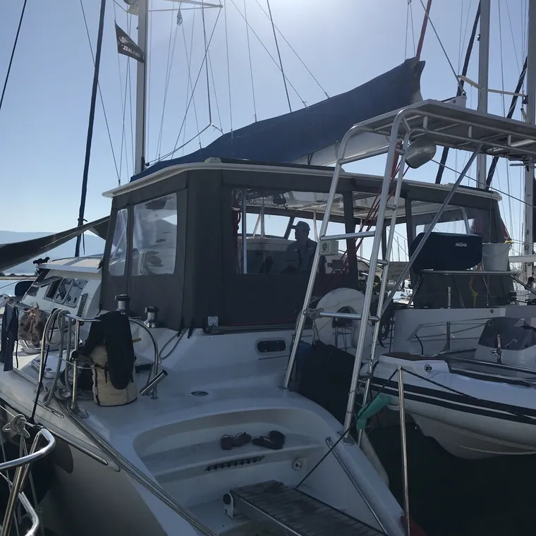 Cockpit enclosure with the side panel rolled open in a sunny marina