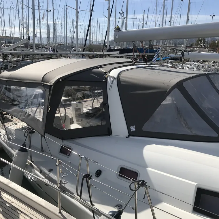 Navy cockpit enclosure with clear windows on a modern sailing yacht