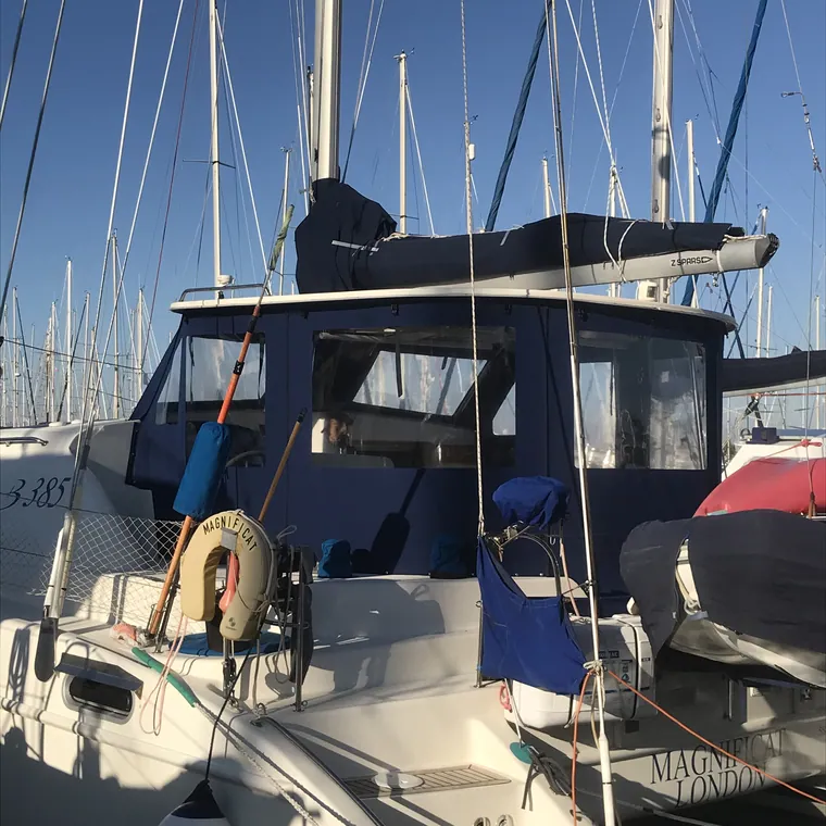 Navy enclosure and cushions in the cockpit of a yacht in a marina
