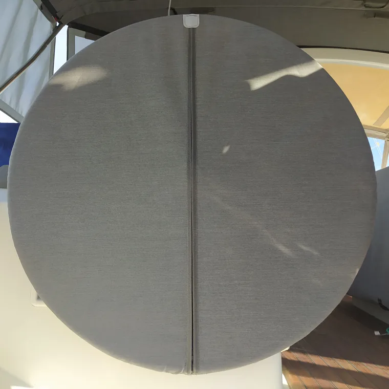Grey cover over the wheel of a yacht in her berth
