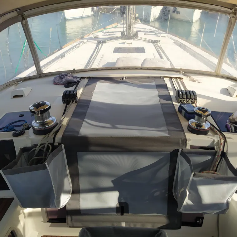 Covers on the helm and winches of a sailing yacht, seen from astern