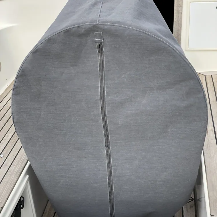 Grey cover over the tender stowed on the foredeck