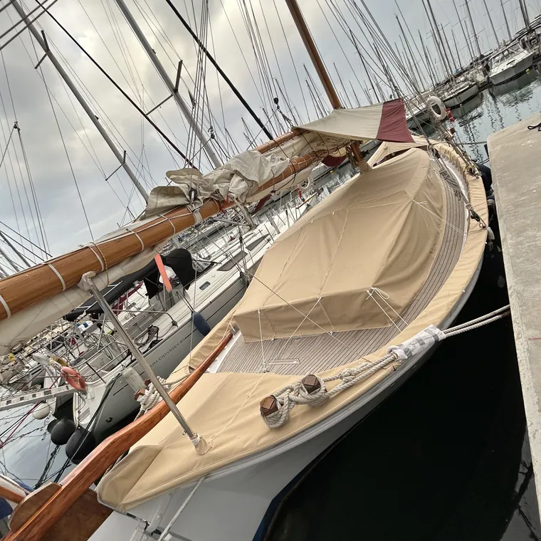 Tan cover over the cockpit of a classic yacht at her mooring