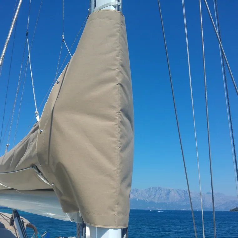 Cream lazy bag closed along the boom, open sea beyond