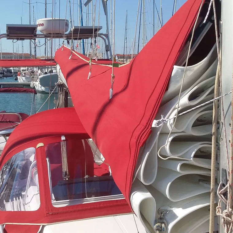 Red lazy bag along the boom of a yacht in a marina