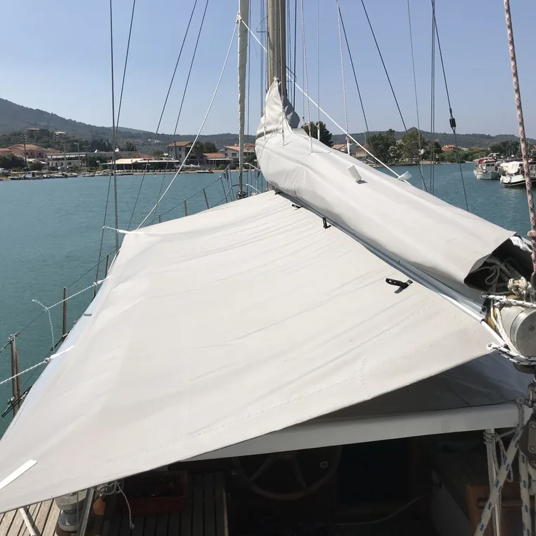 White sail cover on a traditional boat at her mooring