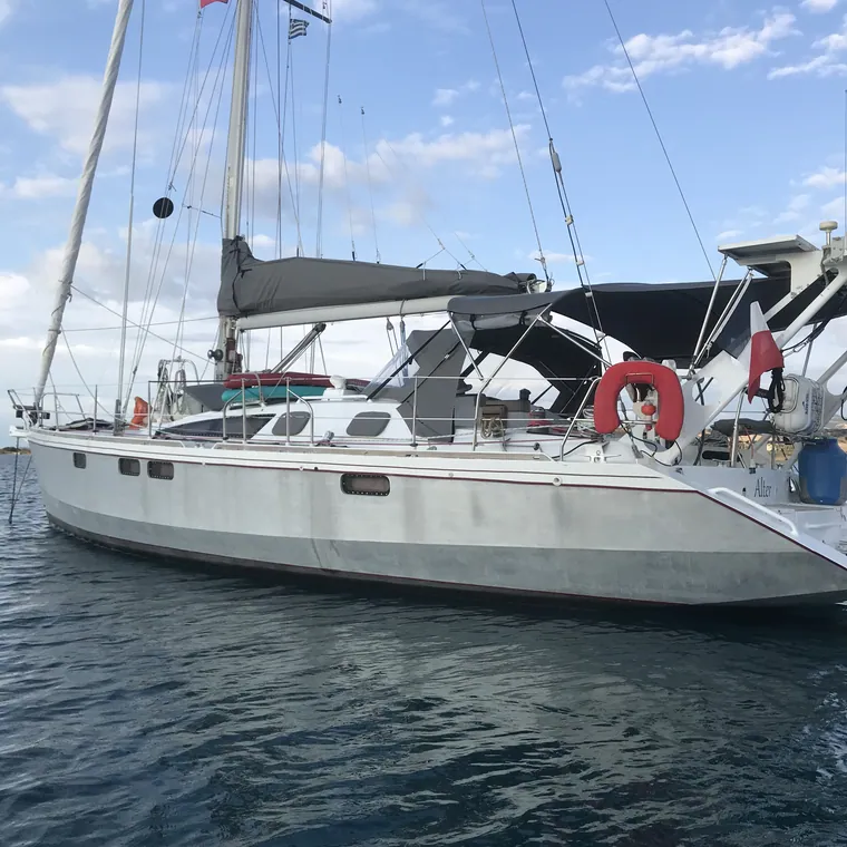 Sailing yacht under way with the mainsail stowed in its lazy bag