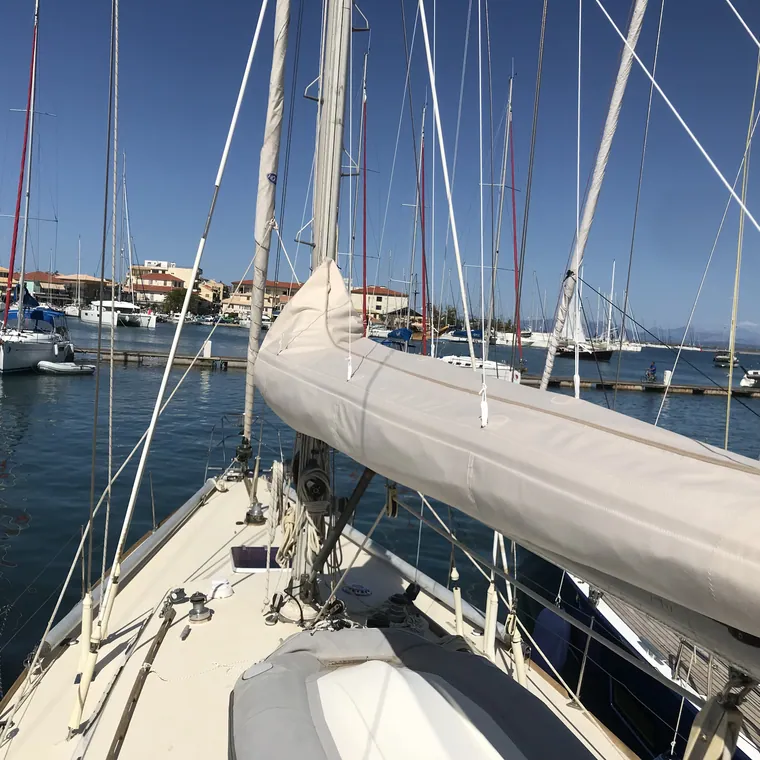 Cream lazy bag on the boom of a yacht berthed stern-to