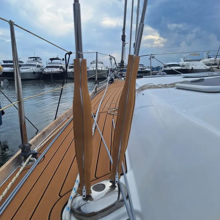 Two laced leather shroud covers along the side deck of a yacht in the marina