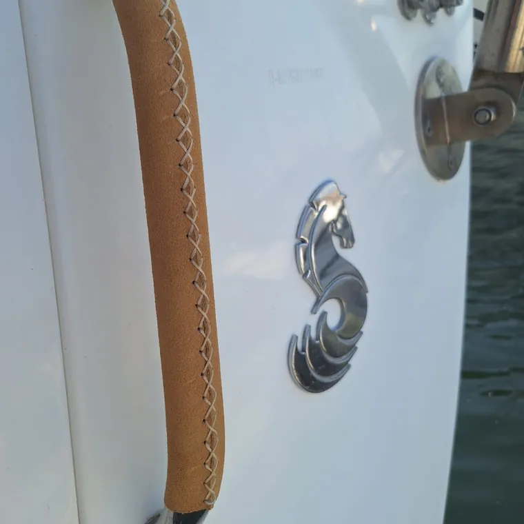 Suede leather cover laced onto a stainless grab handle on the hull