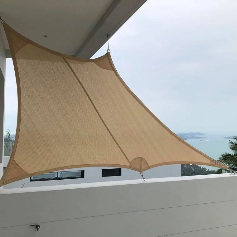 Sand-coloured sail stretched over a roof terrace facing the sea