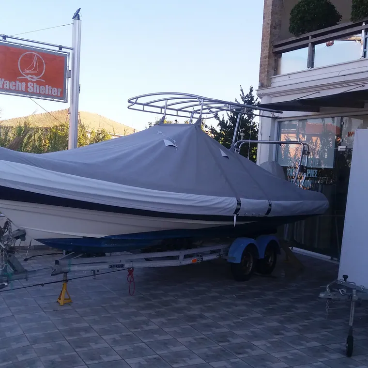 RIB on its trailer under a fitted grey cover