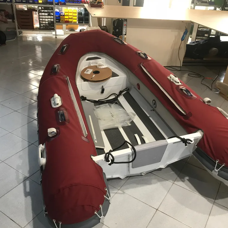 Red RIB with tube covers in the workshop