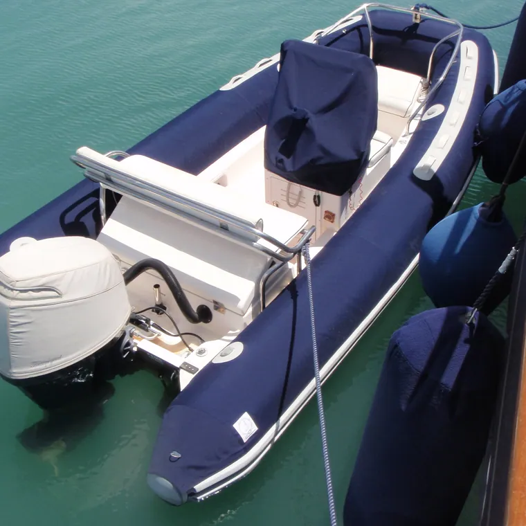 Navy RIB lying alongside in clear water