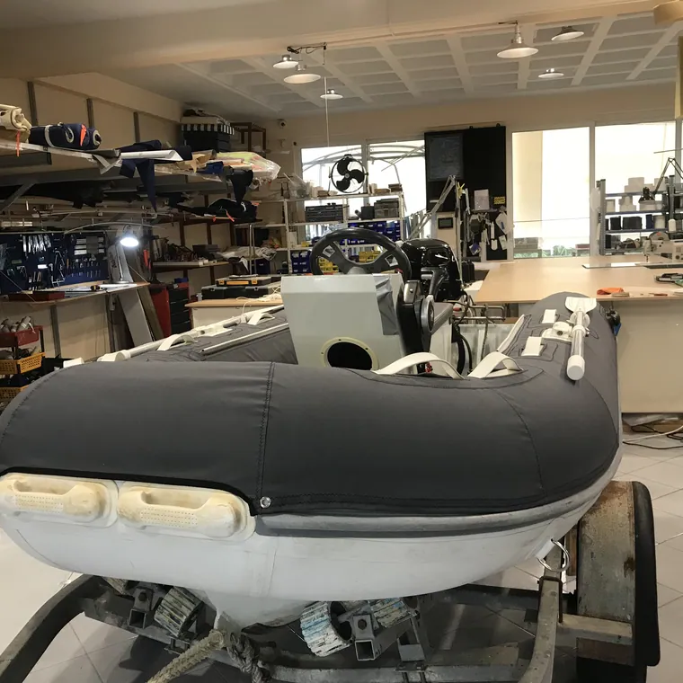 Grey RIB with a fitted cover over the console