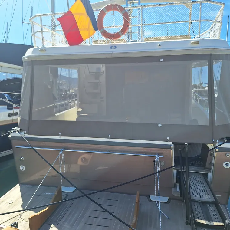 Mesh panel shading the side deck of a motor yacht