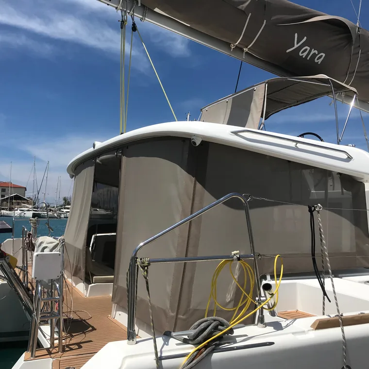 Bimini and side panels over the cockpit, clear water below