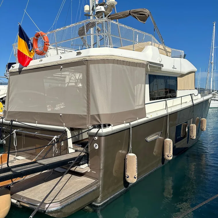 Side panels shading the deck of a motor yacht at anchor