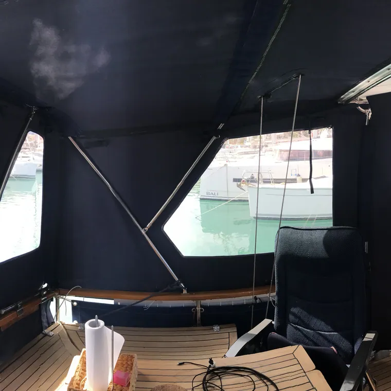 Dark side panels seen from inside the cockpit, looking out over the water