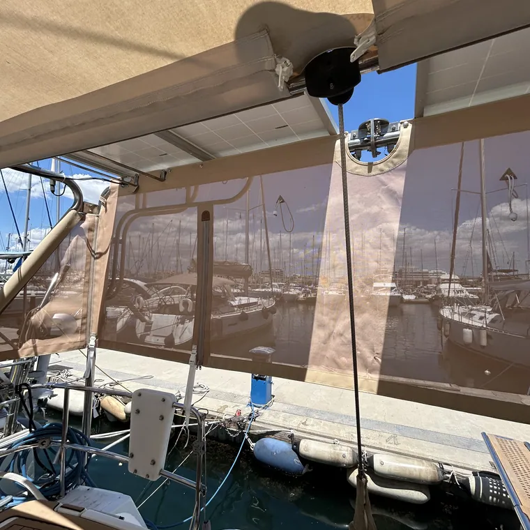 Mesh panels running down the side of a catamaran in the harbour