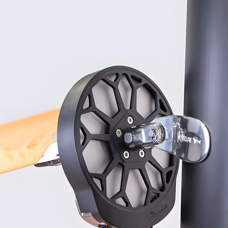 A pulley wheel and its ropes on a pole, an orange sail edge attached