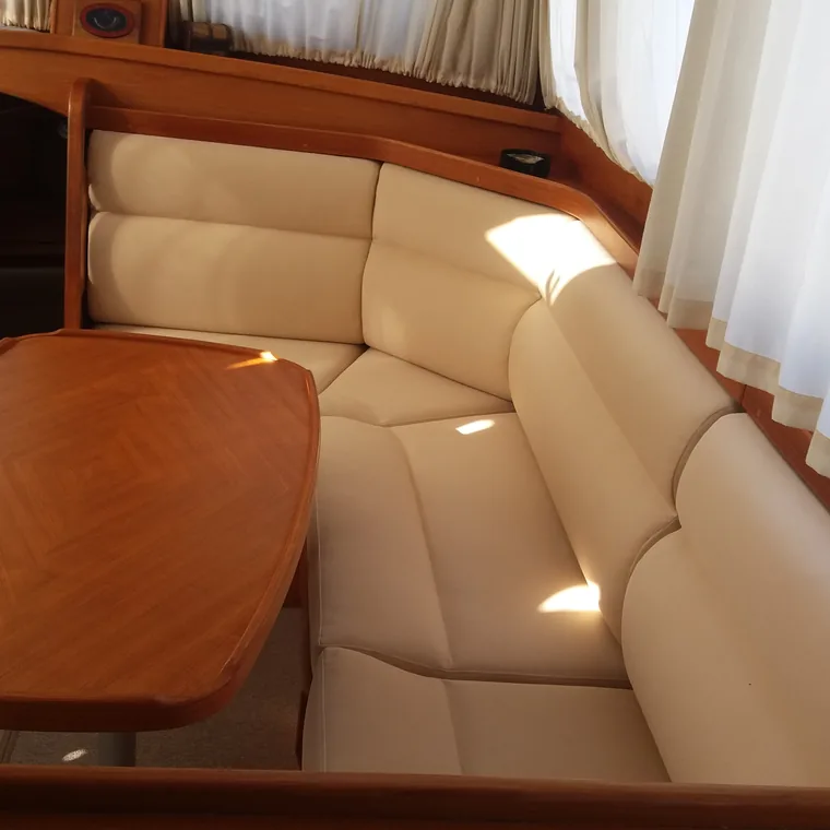 Cream saloon upholstery around a varnished table