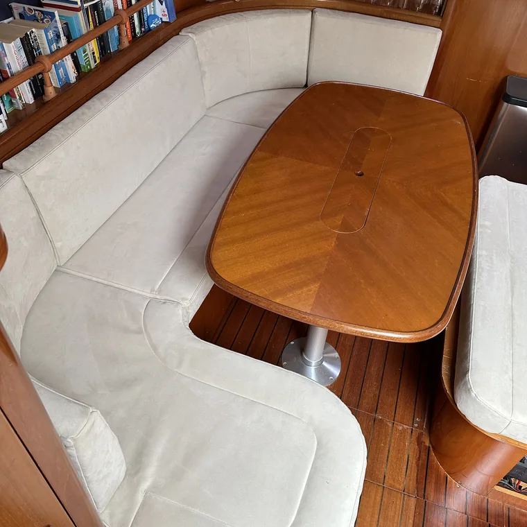 White helm seat and varnished table below decks