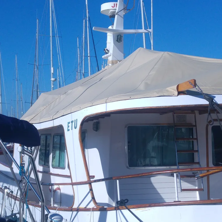 White winter cover over a motor boat's flybridge