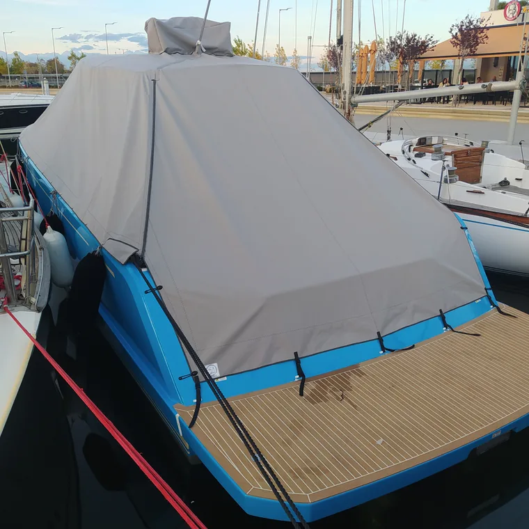 Blue and white winter cover on a boat at her berth