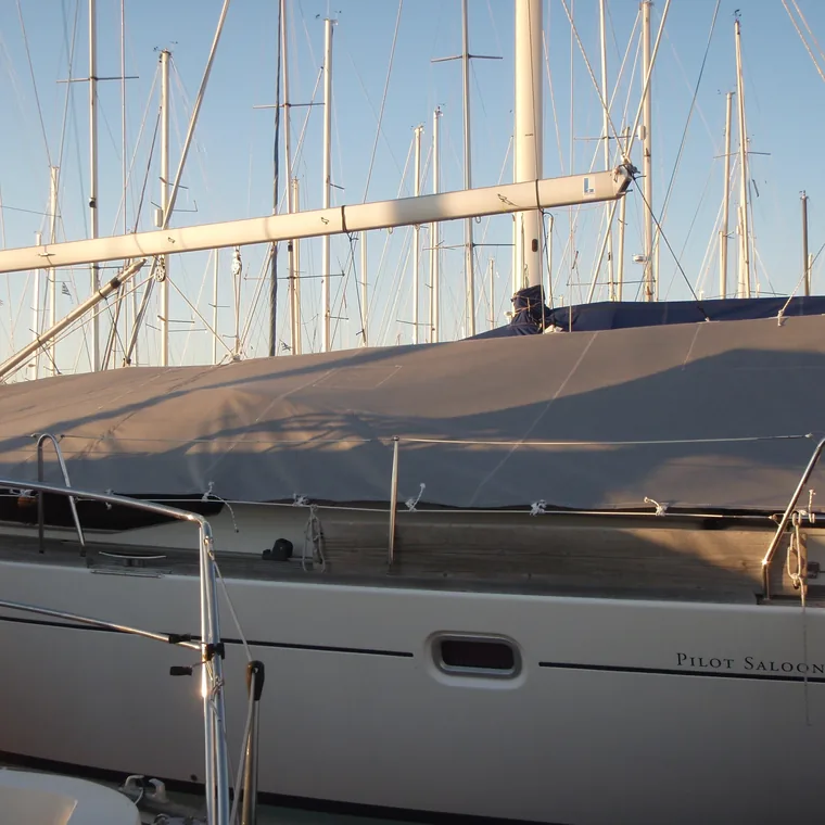 Tan winter cover on a classic yacht in the evening light