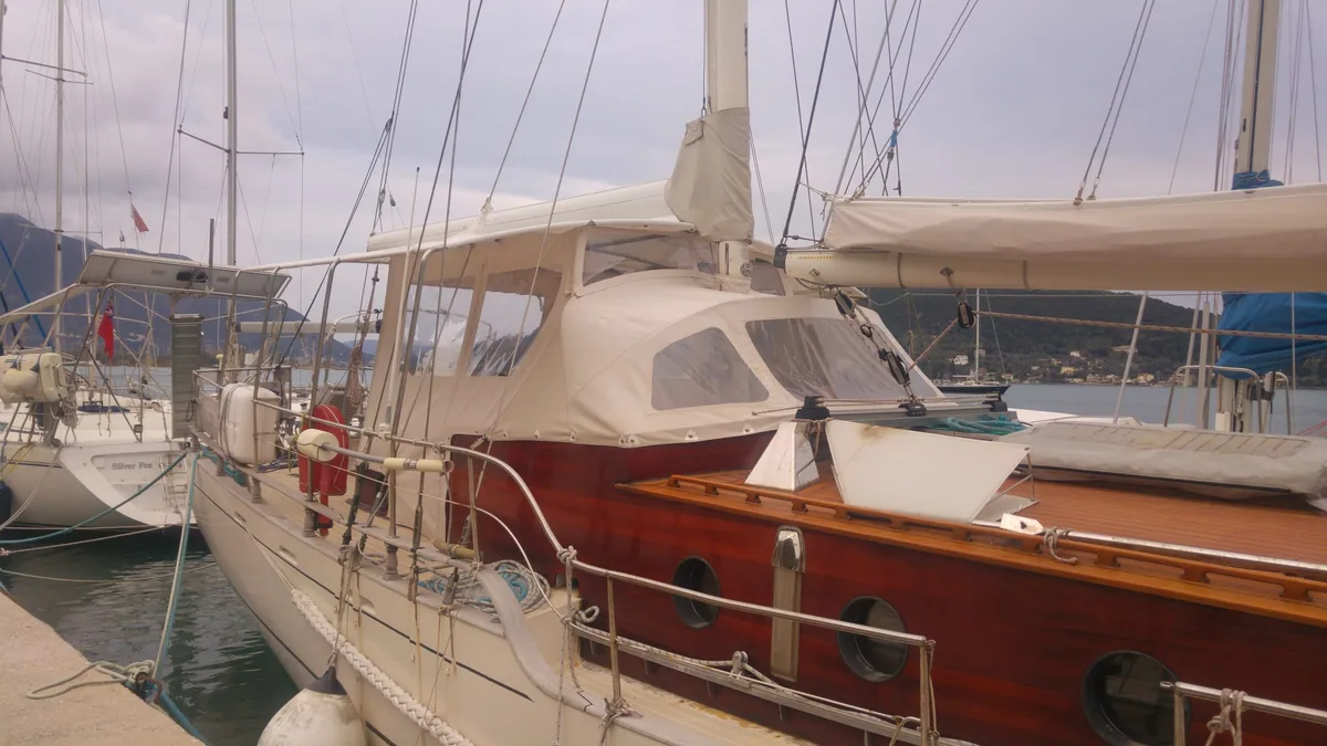 Tan cockpit enclosure fitted on a classic wooden yacht