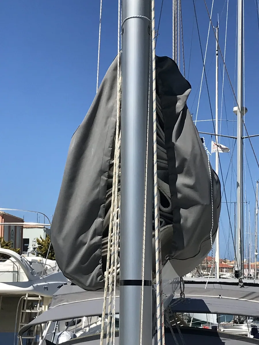 Dark grey lazy bag on the boom, photographed against the mast