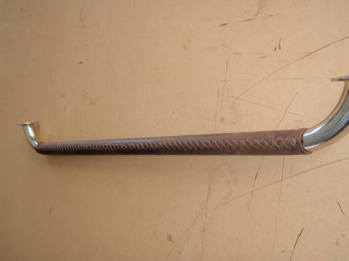 Leather-covered grab rail laid out on the cutting table